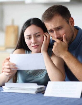 Couple Upset Reading IRS Notice CP14G Together