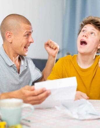 Father and Son Celebrating the Good News in IRS Notice CP74