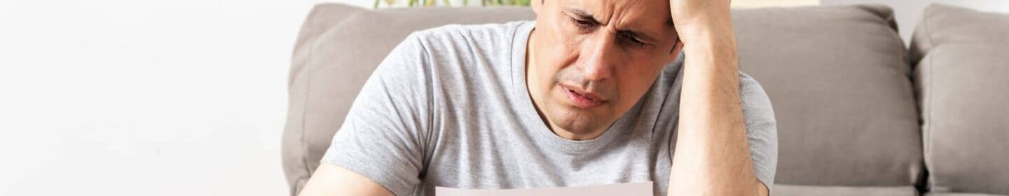 Man Stressed Reading IRS Letter 2566