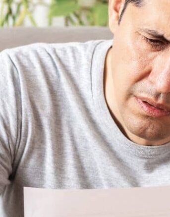 Man Stressed Reading IRS Letter 2566