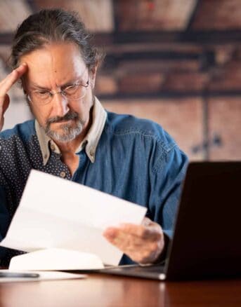 Man Stressed at His Laptop After Reading IRS Notice CP523A
