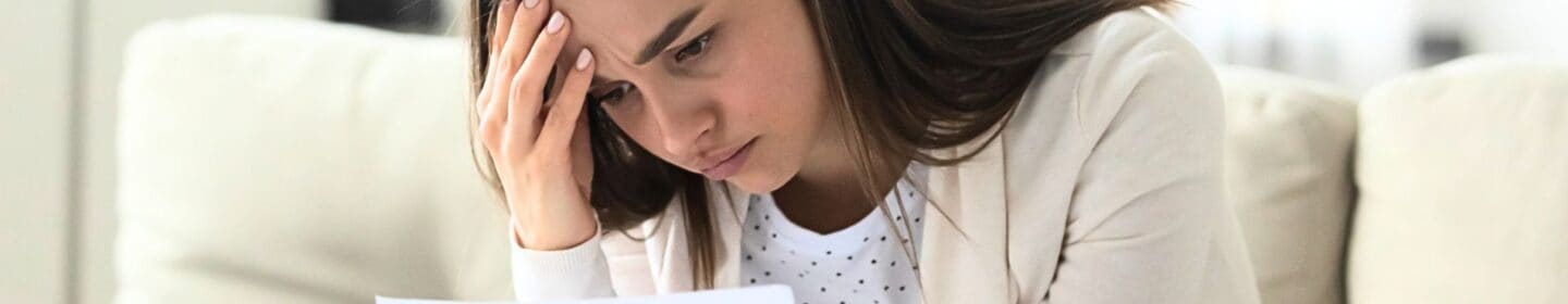 Stressed Woman Reading an IRS Notice of Deficiency