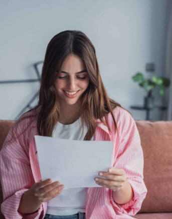 Woman Smiling as She Reads IRS Letter 6459C